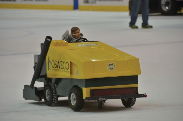Team Mini’s miniature Zamboni is operated by students on the Campus Center Ice Rink to help electrify the crowds and launch T-shirts at them. (Seamus Lyman | The Oswegonian)